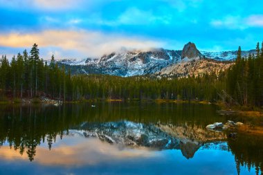 Mammoth California 'da sakin bir gölün üzerinde karla kaplı dağlar yükseliyor. Yoğun ormanlarla çevrili ve suda yansıtılan ikiz şelaleler var. Barışçıl bir yansıma ve taze kar, doğallığı hatırlatıyor.