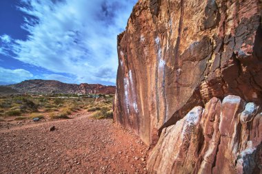 Las Vegas yakınlarındaki Nevada çölünde arkasında Kızıl Kaya Kanyonu ve Kraft Dağı ile birlikte görünen tebeşir çizgileri olan günışığı kaya tırmanış duvarı bulunuyor. Engebeli manzara maceraya davetiye çıkarıyor.