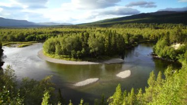 A horseshoe bend in a river in the green hills of Jamtland, Sweden.