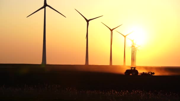 Tractor Cultivating Farmland Sunset Row Wind Turbines — Wideo stockowe