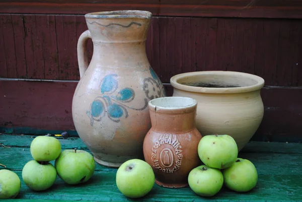 Old vases, bowl, pitcher and apples