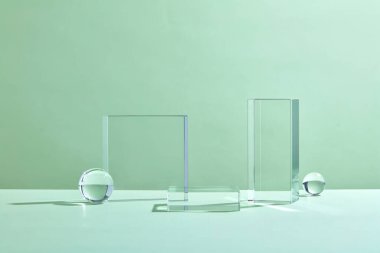 Ürün sergisi için boş podyum. Tek renkli yayalar ve tırtıklı yayalar. Ürün kozmetik sunumu için pastel yeşil renkli cam soyut arkaplan.