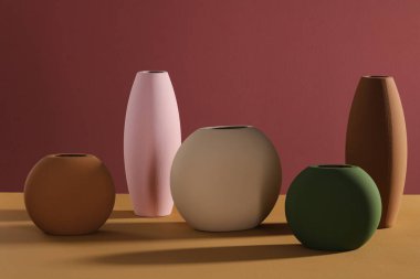 Renkli arkaplanda beş saksı koleksiyonu.