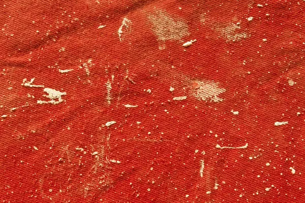 Dirty red cloth with paint spots. — Stock Photo, Image