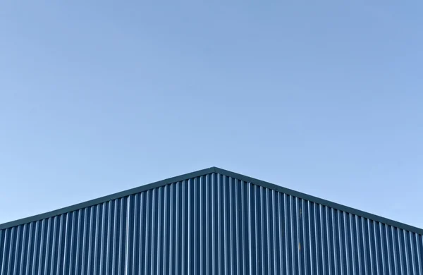 Telhado armazém moderno azul contra o céu azul . — Fotografia de Stock