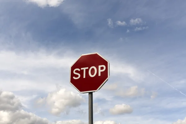 Stop sign against cloudy sky. Royalty Free Stock Photos