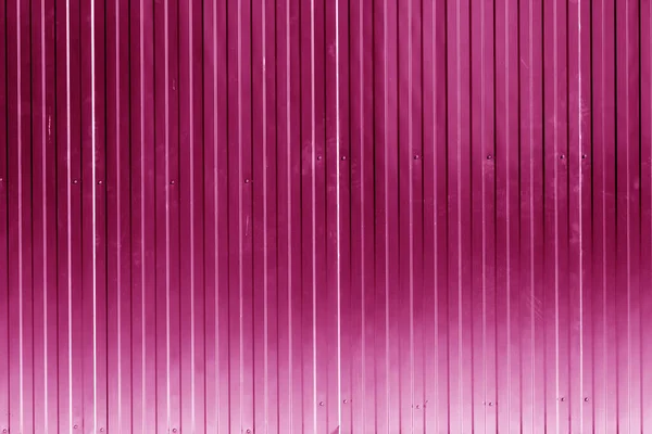Metal sheet fence texture in pink color. Architectural and construction background