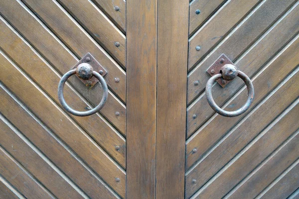 Old metal door hinge on wooden door. Abstract background and texture for design.