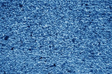 Duvar lacivert tonda taşlarla kaplı. Pis ve yıpranmış arka plan.