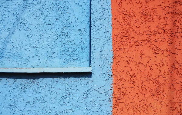 Blaue und orangefarbene Wandtextur. — Stockfoto