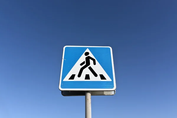 Metalowy znak dla pieszych i błękitne niebo — Zdjęcie stockowe