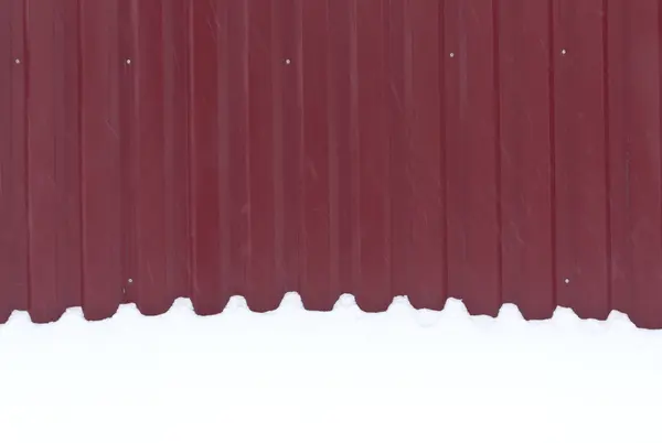 Red metal fence in snow. — Stock Photo, Image