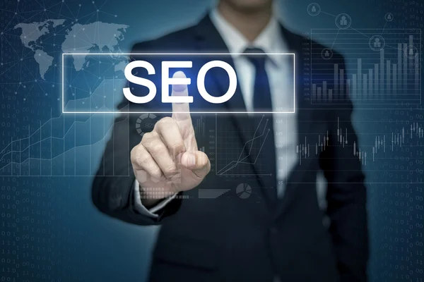 Businessman hand touching SEO button on virtual screen Royalty Free Stock Images