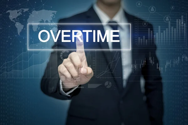 Рука бізнесмена торкається кнопки OVERTIME на віртуальному екрані — стокове фото