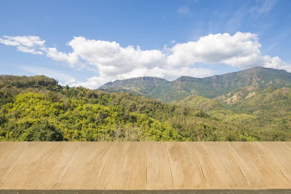 Wood floor with background of mountain view and blue sky — Stock Photo, Image