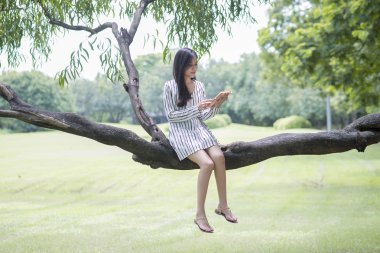 Çekici kadın parkta bir kitap okuma 