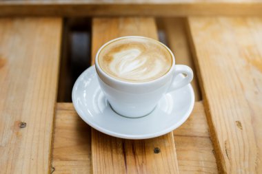 ahşap masa arka plan üzerinde sıcak latte sanat