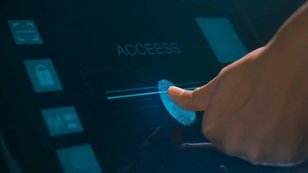 Close up human finger is touching interface computer monitor, fingerprint biometric identity and approval.  future security and password control through fingerprints technology and cybernetic, business