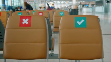 Social distancing chairs in International Airport, Coronavirus prevention concept.	