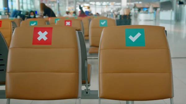 Social distancing chairs in International Airport, Coronavirus prevention concept.	