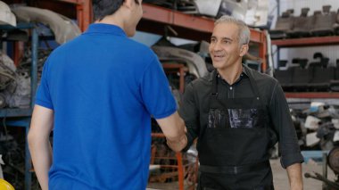 Engineering people are working in heavy industrial plant Engine parts factory .	