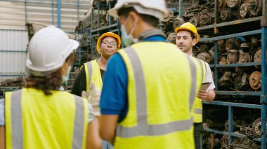 Engineering people are working in heavy industrial plant Engine parts factory .	