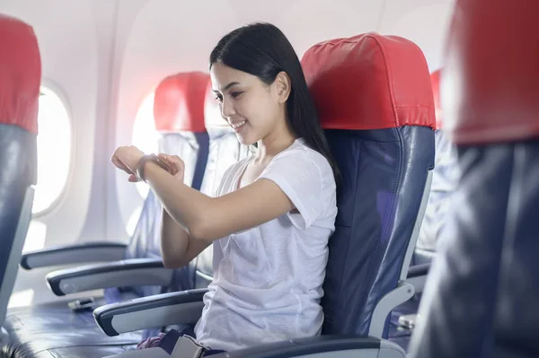 Traveling woman using onboard, technology travel concept