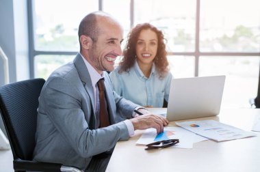 Modern ofiste tartışan ve beyin fırtınası yapan genç bir iş adamı.