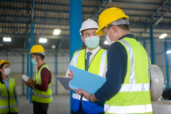 Engineer people are wearing  protective mask working in warehouse