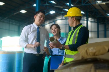 Mühendisler depoda çalışırken koruyucu maske takıyorlar. 