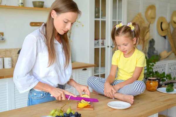 mom and daughter cook healthy food together