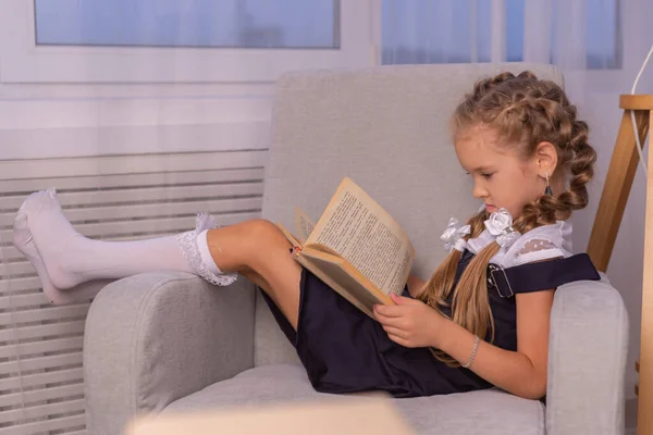 Kız öğrenci evde bir kitap okudu. evde eğitim kavramı