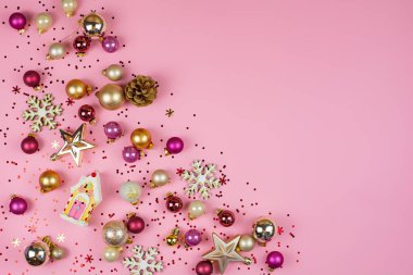 Joyful holiday ornaments and decorations scatter across a lovely pink background, creating festive vibes