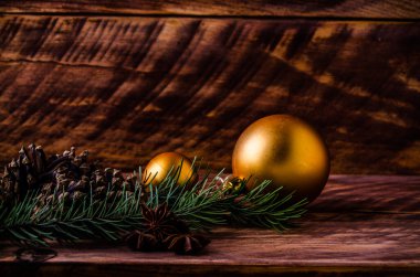 Büyük bir Noel balosuyla tahta tahtaların üzerinde koniler ve dallar