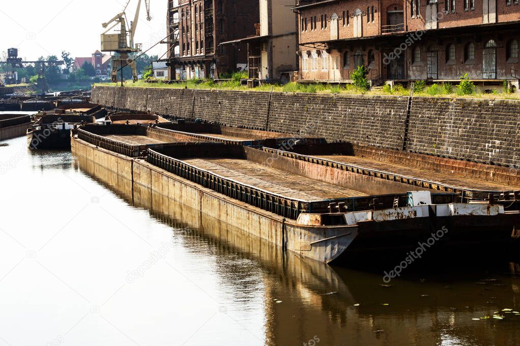 Old barges moored in port. transportation of coal for thermal power plants. Barges waiting to load away