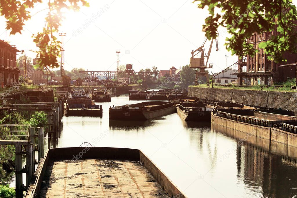 Old barges moored in port. transportation of coal for thermal power plants. Barges waiting to load away