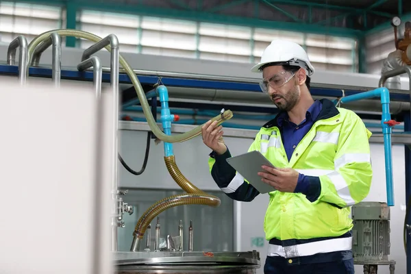 engineer or factory worker using tablet computer for how to fixing tube in factory