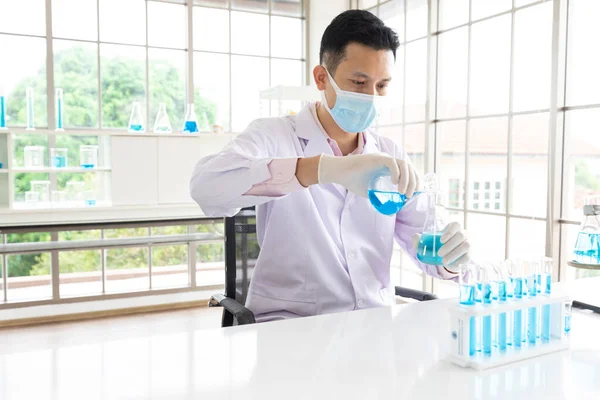 Scientist Man Wearing Medical Face Mask Doing Testing Chemical Experiment Royalty Free Stock Images