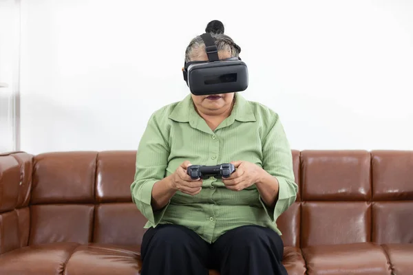 senior woman self learning how to playing game and wearing VR headsets