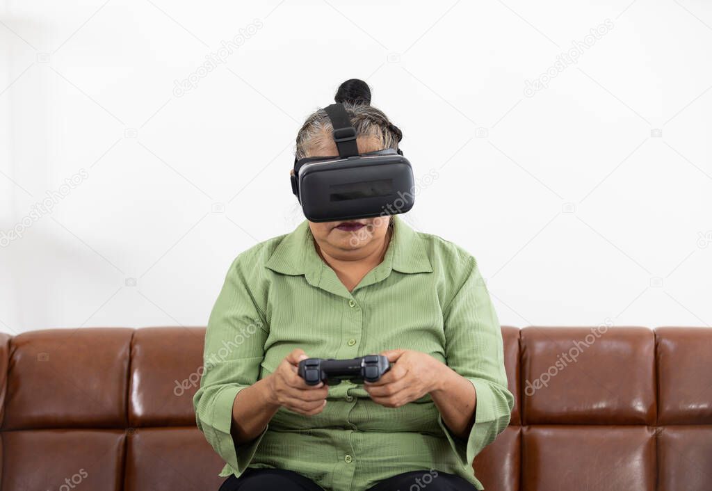 senior woman self learning how to playing game and wearing VR headsets