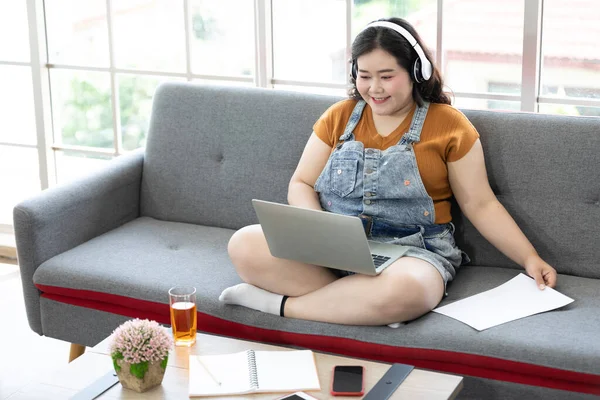 chubby woman works from home and studying with computer laptop