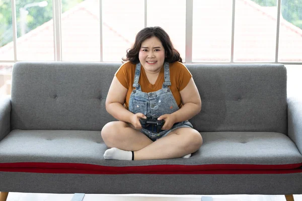 satisfy chubby woman play video games at home