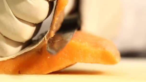 Hands Skinning a Salmon Fish Fillet with a Sharp Knife on a Cutting Board — Stock Video