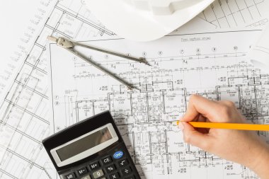Architect working on blueprint clipart