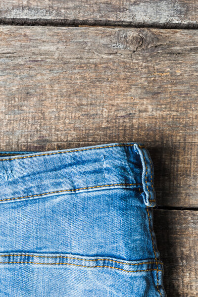 Blue jeans on old wooden surface