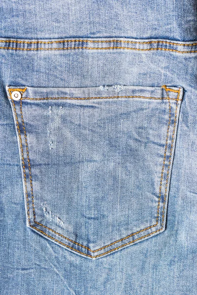 Blue jeans on old wooden surface — Stock Photo, Image