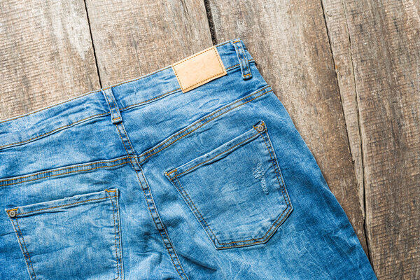 Blue jeans on old wooden surface