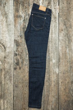 Ahşap arka plan üzerinde kot pantolon