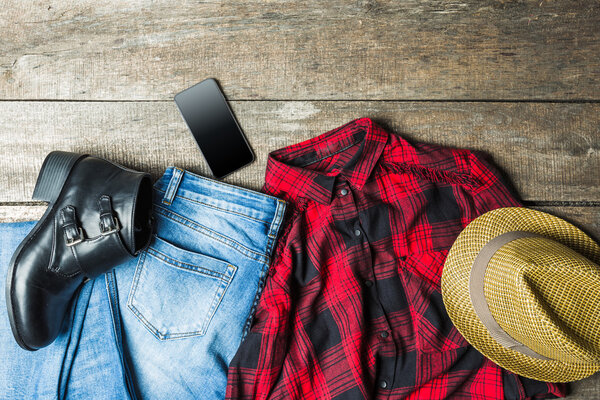 Set of beautiful women's clothing on a wooden background.