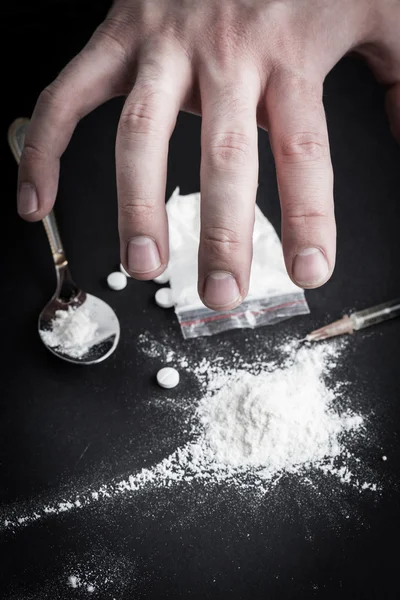 Dirty hand grabbing narcotics — Stock Photo, Image